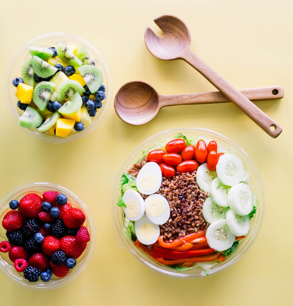 Fruit and salad in bowls on a table